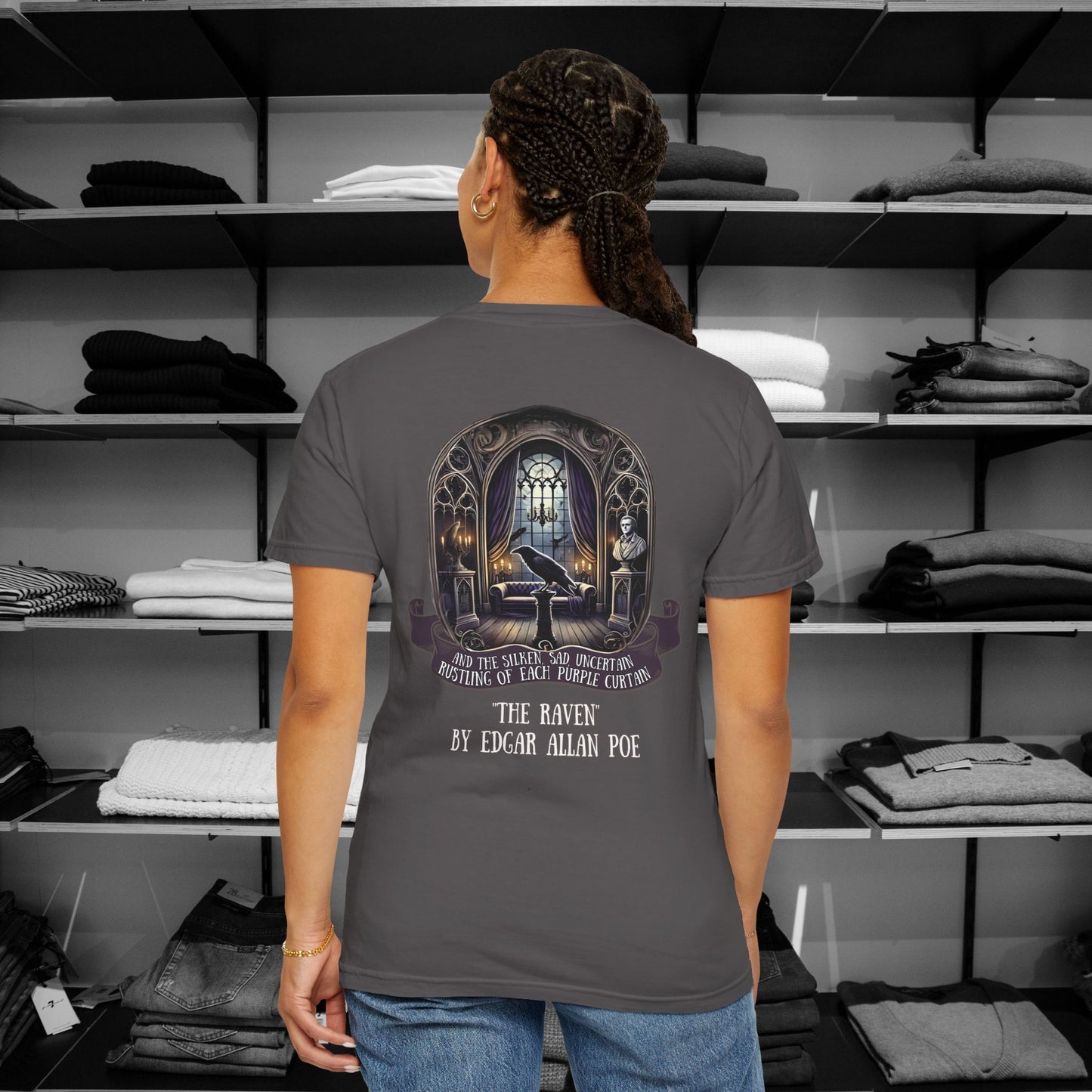 Poetry Clothing "The Raven" Featuring a mesmerizing back design of Poe’s iconic chamber, complete with a moonlit window, the bust of Pallas, and the ever-watchful raven, this "The Raven" t shirt brings literary elegance to your festive wardrobe. The ornate gothic arches and glowing candles capture the eerie yet enchanting spirit of the season. A minimalist raven silhouette on the front adds a subtle touch of mystery.