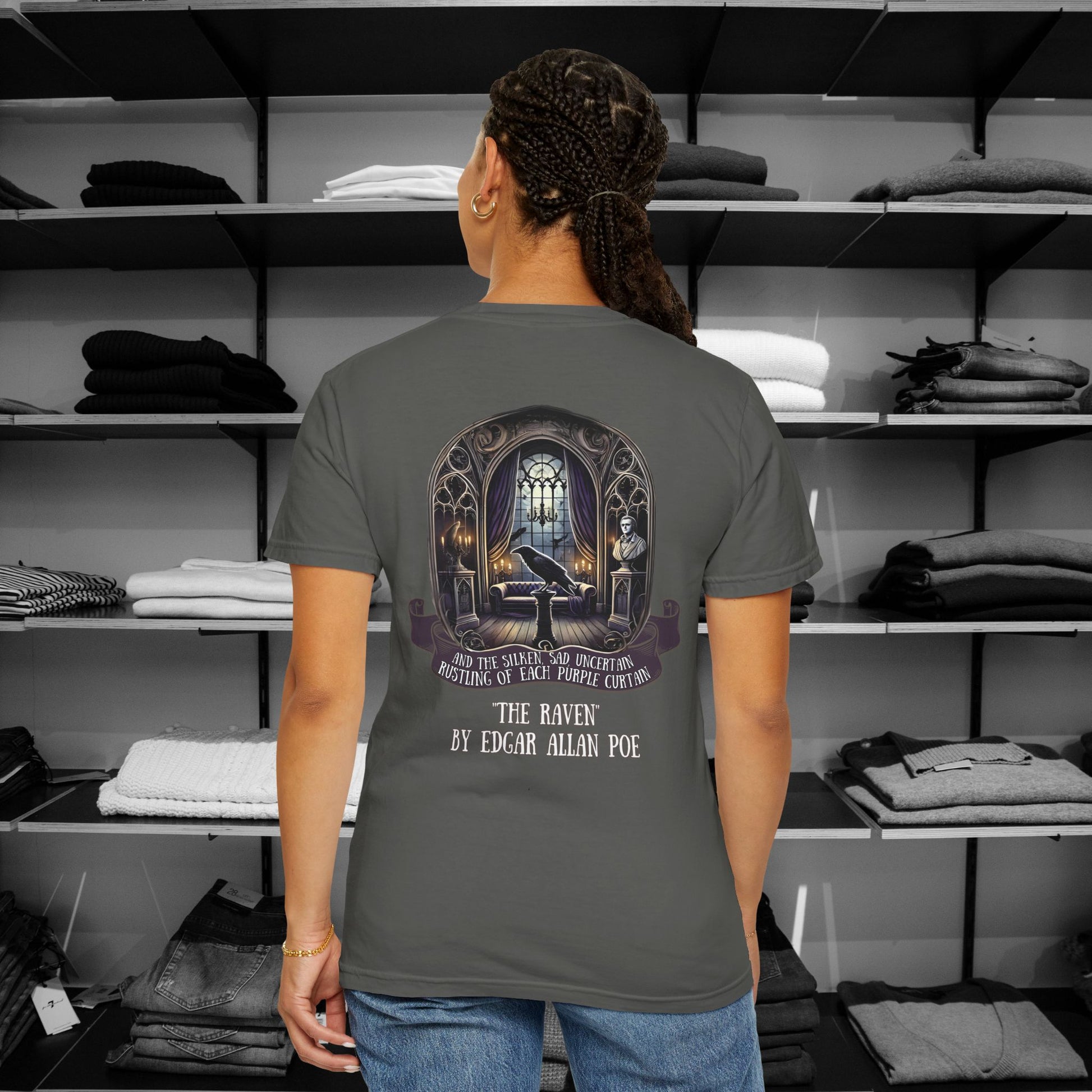 Poetry Clothing "The Raven" Featuring a mesmerizing back design of Poe’s iconic chamber, complete with a moonlit window, the bust of Pallas, and the ever-watchful raven, this "The Raven" t shirt brings literary elegance to your festive wardrobe. The ornate gothic arches and glowing candles capture the eerie yet enchanting spirit of the season. A minimalist raven silhouette on the front adds a subtle touch of mystery.