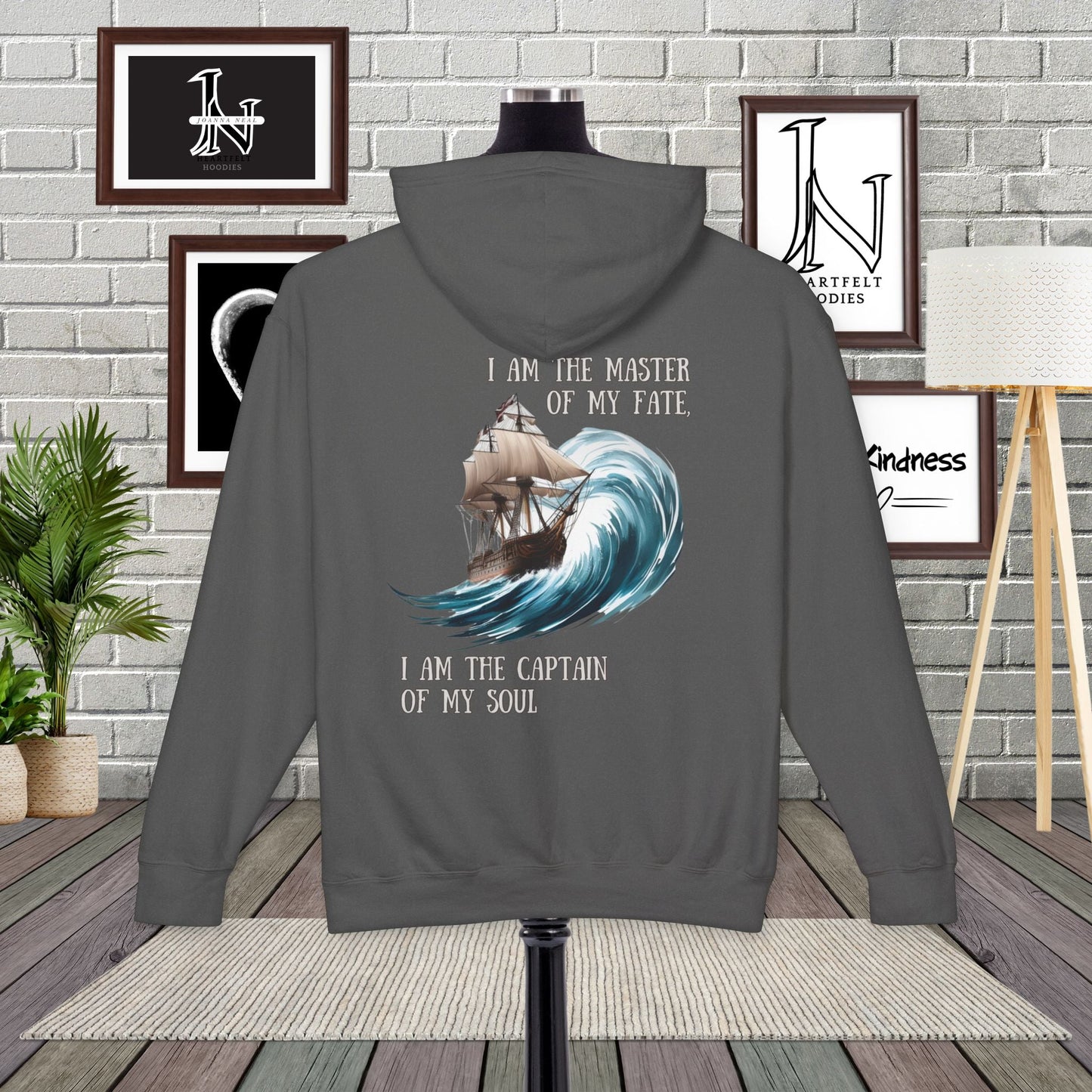 This Piece of Poetry Clothing features a bold and motivational statement: "I am the captain of my soul," paired with a stunning mountain scene under a rising sun.