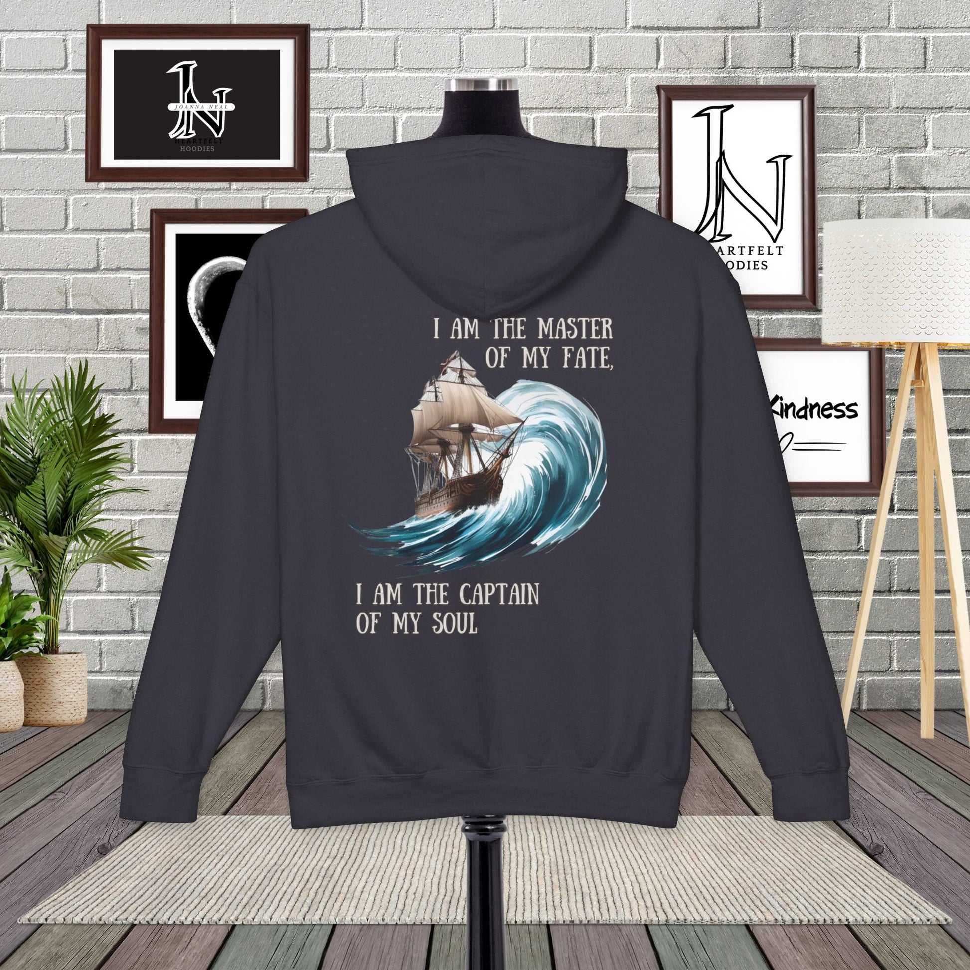 This Piece of Poetry Clothing features a bold and motivational statement: "I am the captain of my soul," paired with a stunning mountain scene under a rising sun.