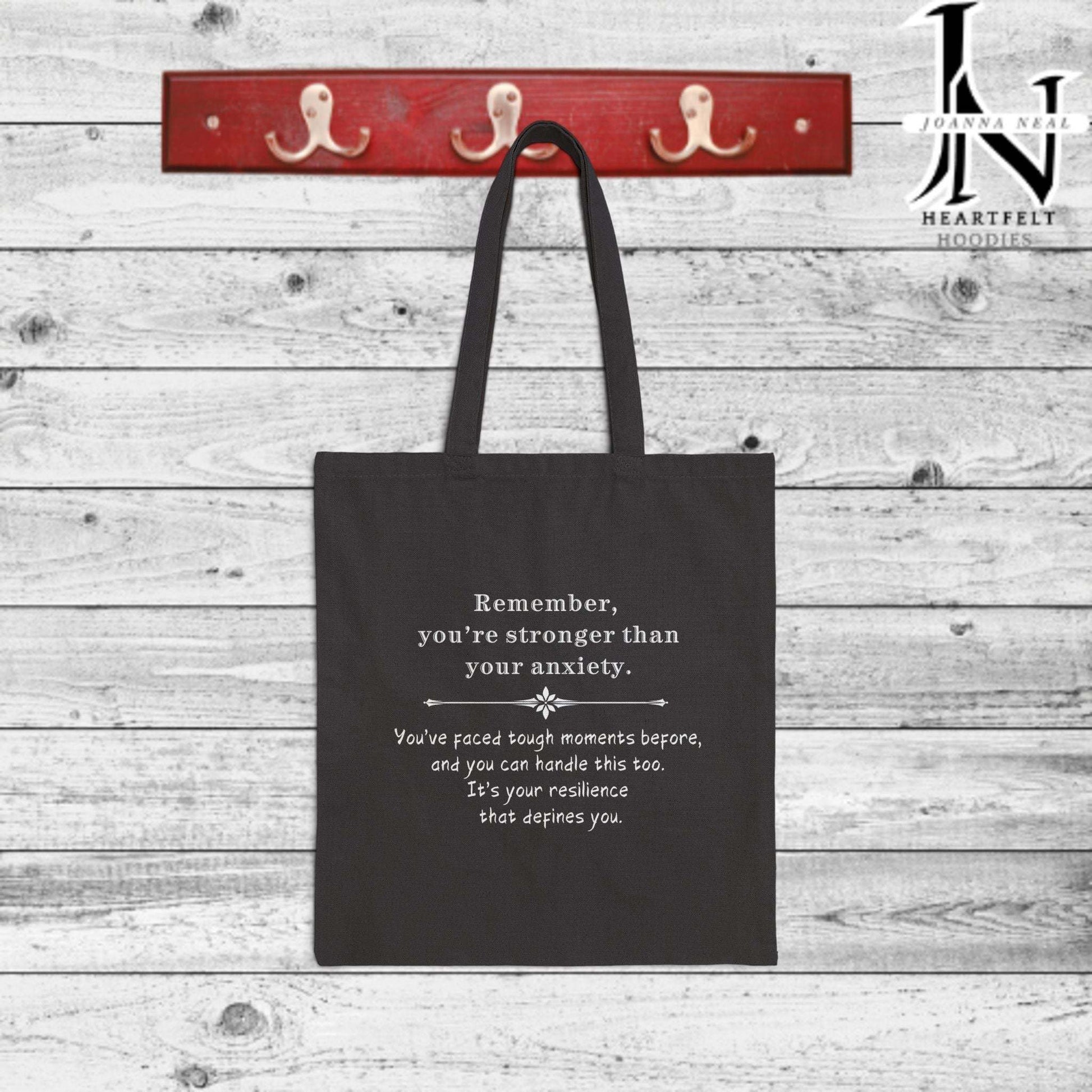 Anxiety can feel overwhelming, but a simple reminder can make all the difference. This Anxiety Cotton Canvas Tote Bag is designed to spread a message of strength and hope with the phrase, "Remember you're stronger than your anxiety