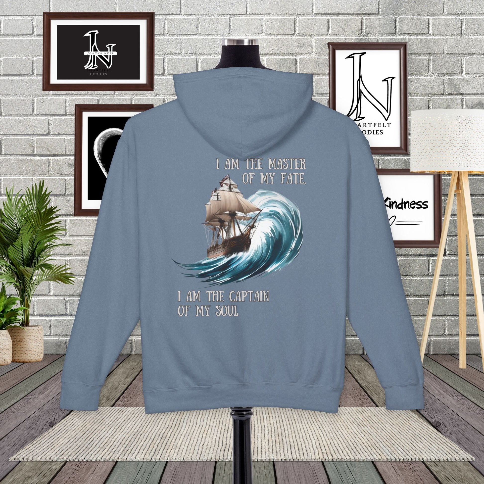 This Piece of Poetry Clothing features a bold and motivational statement: "I am the captain of my soul," paired with a stunning mountain scene under a rising sun.