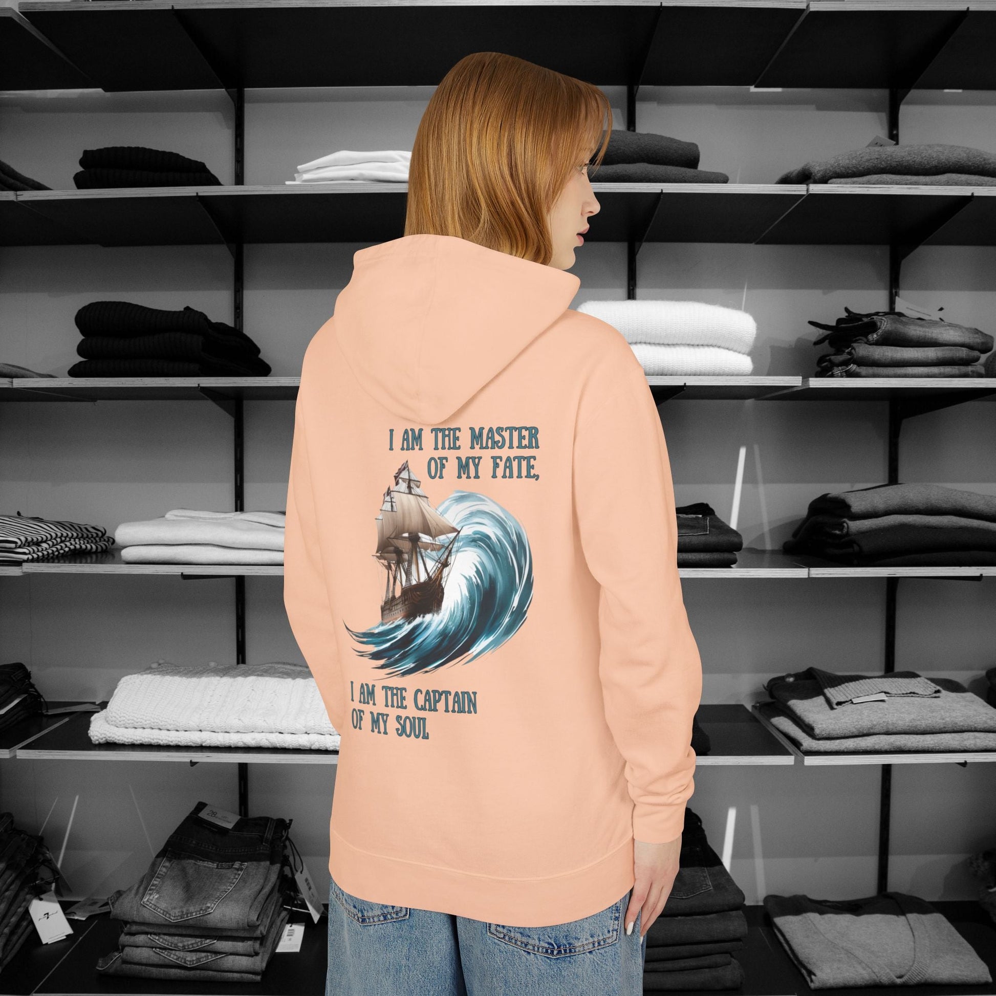 This Piece of Poetry Clothing features a bold and motivational statement: "I am the captain of my soul," paired with a stunning mountain scene under a rising sun.