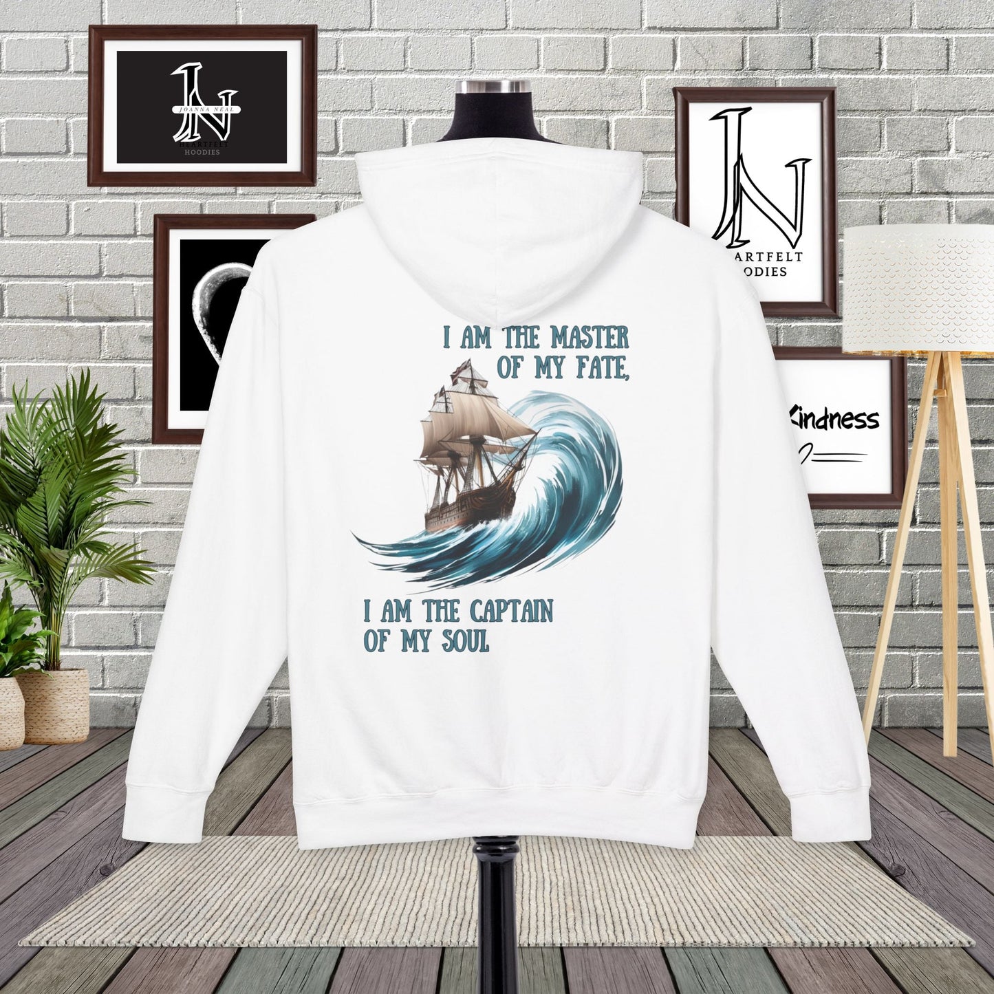 This Piece of Poetry Clothing features a bold and motivational statement: "I am the captain of my soul," paired with a stunning mountain scene under a rising sun.